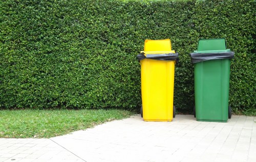Workers sorting recyclables into separate streams at a clearance site in Hatch End
